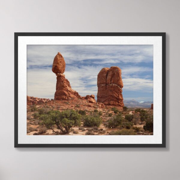 A stunning view of Balanced Rock at Arches National Park in Moab, Utah, with a backdrop of the desert and sky.