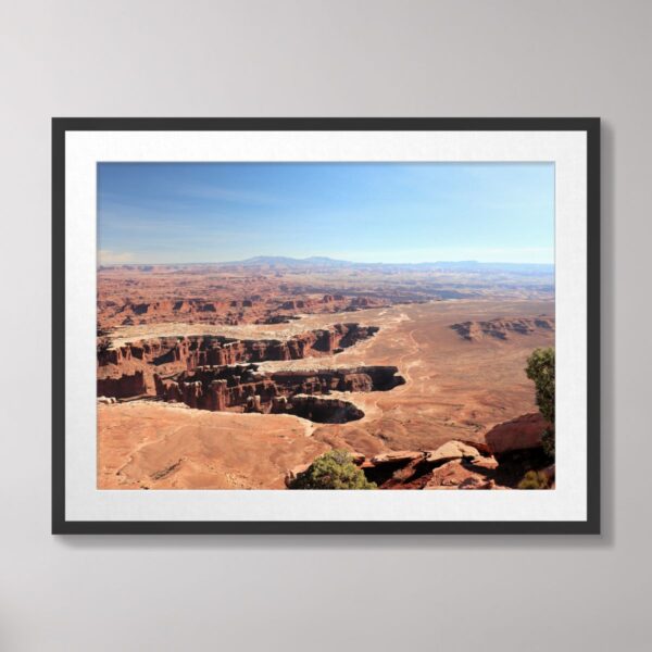 A stunning view of Grand View Point at Canyonlands National Park in Moab, Utah, showcasing dramatic canyons and mesas under a clear blue sky.