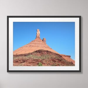 A breathtaking view of Castle Valley in Moab, Utah, featuring vibrant red-rock formations under a clear blue sky.