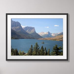 A stunning view of Saint Mary Lake at Glacier National Park, with turquoise waters, Wild Goose Island, and surrounding mountain peaks under a bright blue sky.