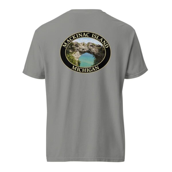 Grey Comfort Colors 1717 heavyweight T-shirt featuring Arch Rock on Mackinac Island, Michigan, with a scenic lake view framed by natural rock formations in an oval design.