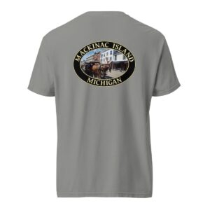 Grey Comfort Colors 1717 heavyweight T-shirt featuring downtown Mackinac Island horse and carriage graphic with historic buildings in an oval design.