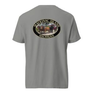 Grey Comfort Colors 1717 heavyweight T-shirt featuring a horse and carriage on the West Bluff of Mackinac Island, with historic Victorian homes and lush greenery in an oval design.