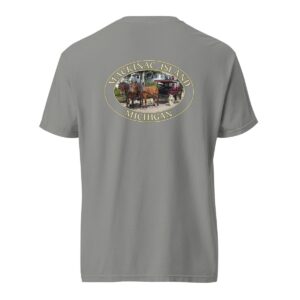 Grey Comfort Colors 1717 heavyweight T-shirt featuring a horse and carriage on the West Bluff of Mackinac Island, with historic Victorian homes and lush greenery in an oval design.