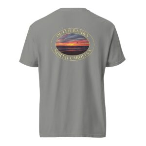 Grey Comfort Colors 1717 heavyweight T-shirt featuring a vibrant Kitty Hawk sunrise graphic in Outer Banks, North Carolina, with colorful clouds over the ocean horizon in an oval design.