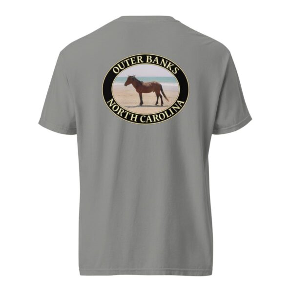 Grey Comfort Colors 1717 heavyweight T-shirt featuring a graphic of a wild horse on the sandy beaches of the Outer Banks, North Carolina, with the ocean in the background, in an oval design.