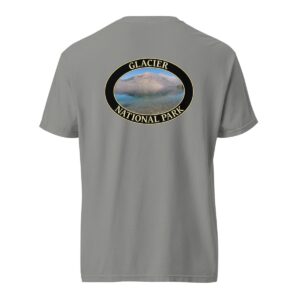 Grey Comfort Colors 1717 heavyweight T-shirt featuring Lake McDonald at Glacier National Park graphic with mountains and water reflection in an oval design.