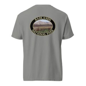 Grey Comfort Colors 1717 heavyweight T-shirt featuring a scenic graphic of reeds at Badlands National Park, framed in an oval design.