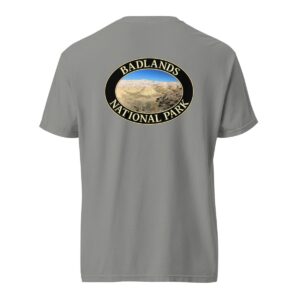 Grey Comfort Colors heavyweight T-shirt featuring a scenic Yellow Mounds design at Badlands National Park, framed in an oval border.