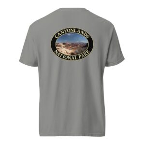 Grey Comfort Colors heavyweight T-shirt featuring a scenic landscape of Canyonlands National Park in Moab, framed in an oval border.