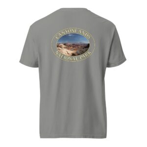 Grey Comfort Colors heavyweight T-shirt featuring a scenic landscape of Canyonlands National Park in Moab, framed in an oval border.