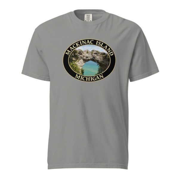 Grey Comfort Colors 1717 heavyweight T-shirt featuring Arch Rock on Mackinac Island, Michigan, with a scenic lake view framed by natural rock formations in an oval design.