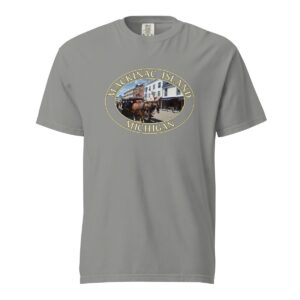 Grey Comfort Colors 1717 heavyweight T-shirt featuring downtown Mackinac Island horse and carriage graphic with historic buildings in an oval design.