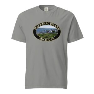 Grey Comfort Colors 1717 heavyweight T-shirt featuring Mackinac Island harbor and downtown graphic with boats and historic buildings in an oval design.