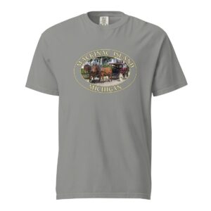 Grey Comfort Colors 1717 heavyweight T-shirt featuring a horse and carriage on the West Bluff of Mackinac Island, with historic Victorian homes and lush greenery in an oval design.