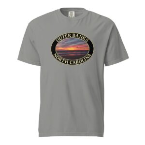 Grey Comfort Colors 1717 heavyweight T-shirt featuring a vibrant Kitty Hawk sunrise graphic in Outer Banks, North Carolina, with colorful clouds over the ocean horizon in an oval design.