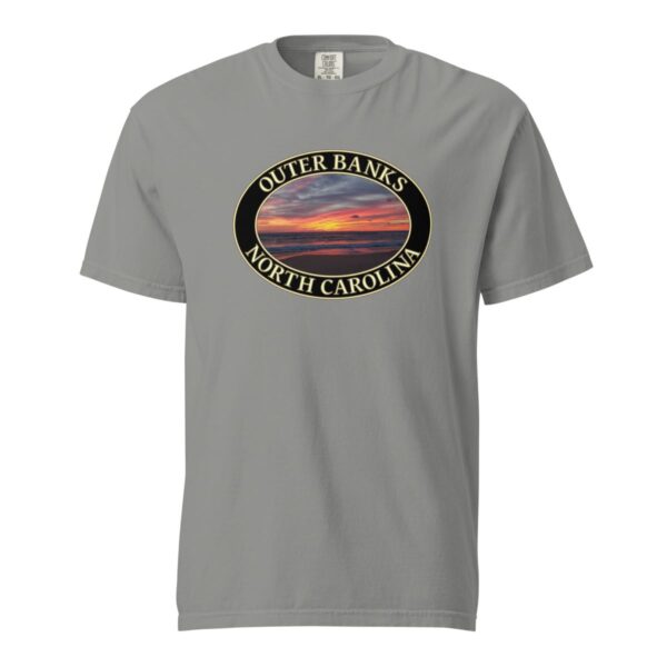 Grey Comfort Colors 1717 heavyweight T-shirt featuring a vibrant Kitty Hawk sunrise graphic in Outer Banks, North Carolina, with colorful clouds over the ocean horizon in an oval design.