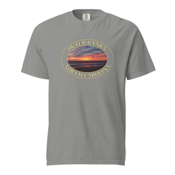 Grey Comfort Colors 1717 heavyweight T-shirt featuring a vibrant Kitty Hawk sunrise graphic in Outer Banks, North Carolina, with colorful clouds over the ocean horizon in an oval design.