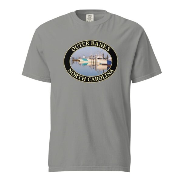 Grey Comfort Colors 1717 heavyweight T-shirt featuring a fishing boats graphic at Oregon Inlet, Outer Banks, North Carolina, with calm water reflections and a clear sky in an oval design.