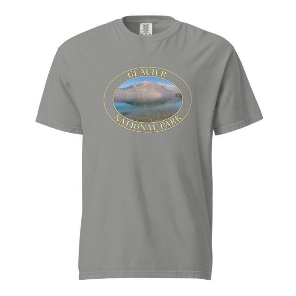 Grey Comfort Colors 1717 heavyweight T-shirt featuring Lake McDonald at Glacier National Park graphic with mountains and water reflection in an oval design.