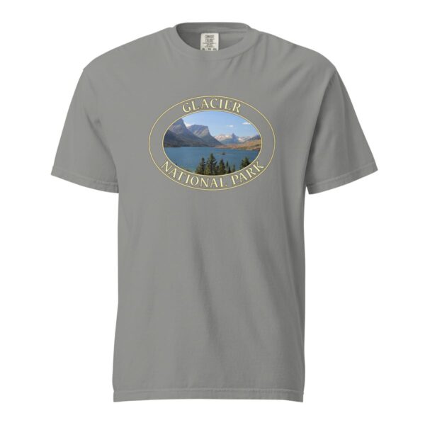 Grey Comfort Colors 1717 heavyweight T-shirt featuring Saint Mary Lake at Glacier National Park graphic with mountain peaks, evergreen trees, and blue waters in an oval design.