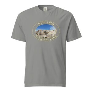 Grey Comfort Colors 1717 heavyweight T-shirt featuring a scenic graphic of Badlands National Park, framed in an oval design.