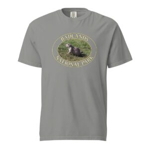 Grey Comfort Colors 1717 heavyweight T-shirt featuring a graphic of a prairie dog at Badlands National Park, framed in an oval design.