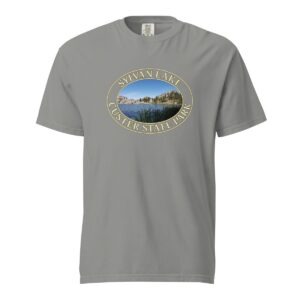 Grey Comfort Colors heavyweight T-shirt featuring a scenic Sylvan Lake design at Custer State Park, framed in an oval border.