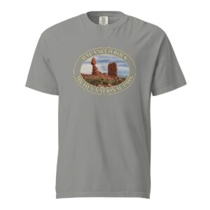 Grey Comfort Colors heavyweight T-shirt featuring the iconic Balanced Rock at Arches National Park, framed in an oval border.