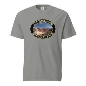 Grey Comfort Colors heavyweight T-shirt featuring a scenic landscape of Canyonlands National Park in Moab, framed in an oval border.