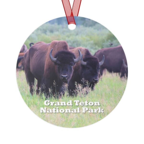 A 3.5-inch ornament depicting wild buffalo grazing in the grasslands of Grand Teton National Park. Made of lightweight aluminum with a glossy finish and red ribbon for hanging.