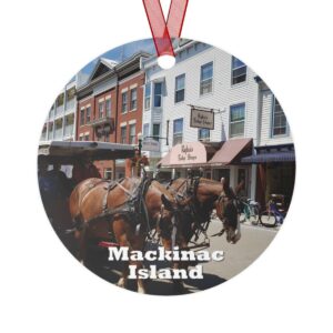 Mackinac Island ornament featuring a horse and carriage in downtown, printed on a 3.5-inch aluminum circle with a red ribbon for hanging