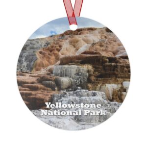 A detailed ornament featuring Mammoth Hot Springs at Yellowstone National Park, showcasing the terraced travertine formations. Made from durable aluminum with a glossy finish, this 3.5-inch ornament includes a red ribbon for easy hanging.