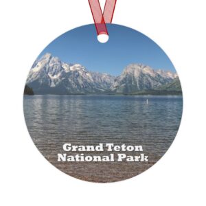 A 3.5-inch ornament showcasing Jackson Lake at Grand Teton National Park, with the majestic Teton Range reflected in the tranquil water. Made of lightweight aluminum with a glossy finish, it includes a red ribbon for easy hanging.