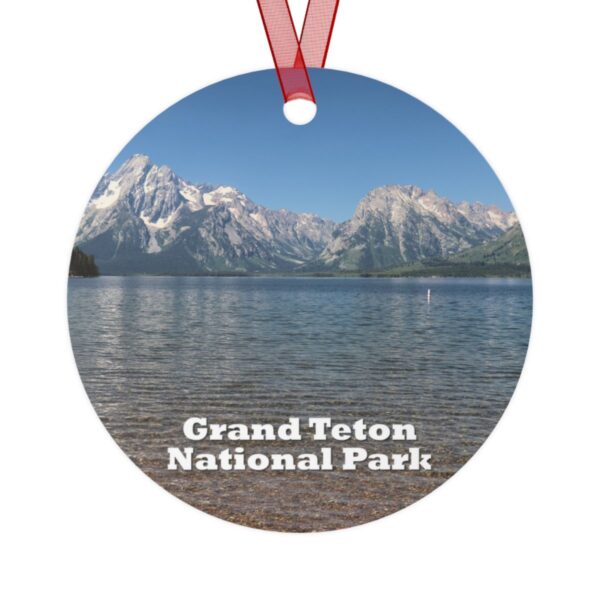 A 3.5-inch ornament showcasing Jackson Lake at Grand Teton National Park, with the majestic Teton Range reflected in the tranquil water. Made of lightweight aluminum with a glossy finish, it includes a red ribbon for easy hanging.