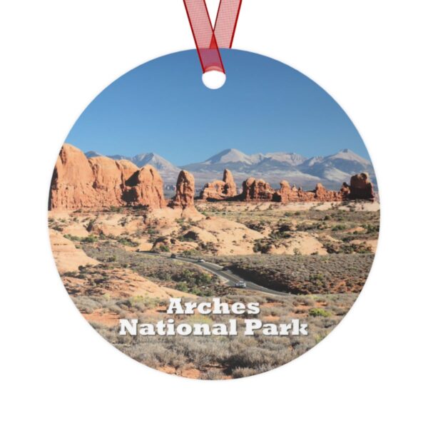 Double-sided aluminum ornament featuring a vibrant image of The Windows at Arches National Park, showcasing iconic red rock formations under a clear blue sky.