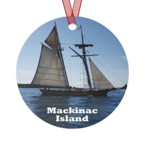 Mackinac Island ornament featuring a schooner sailing on Lake Huron, printed on a 3.5-inch aluminum circle with a red ribbon for hanging