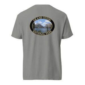 Grey Comfort Colors heavyweight T-shirt featuring a scenic image of Jenny Lake at Grand Teton National Park, framed in an oval border.