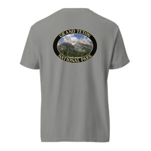 Grey Comfort Colors heavyweight T-shirt featuring a scenic image of the Grand Teton Mountains at Grand Teton National Park, framed in an oval border.