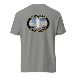 Grey Comfort Colors heavyweight T-shirt featuring a scenic image of the Old Faithful Geyser erupting at Yellowstone National Park, framed in an oval border.