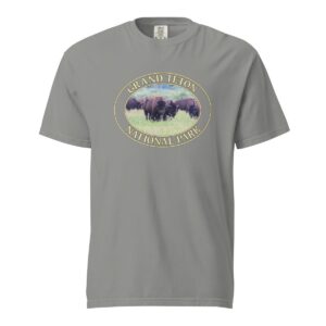 Grey Comfort Colors heavyweight T-shirt featuring a scenic image of wild buffalo grazing at Grand Teton National Park, framed in an oval border.