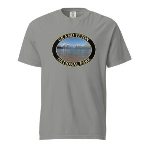 Grey Comfort Colors heavyweight T-shirt featuring a scenic image of Jackson Lake at Grand Teton National Park, framed in an oval border.