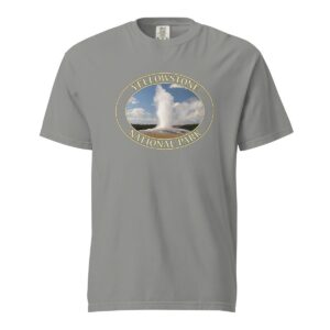 Grey Comfort Colors heavyweight T-shirt featuring a scenic image of the Old Faithful Geyser erupting at Yellowstone National Park, framed in an oval border.