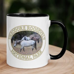 Wild horses coffee mug featuring the untamed beauty of Theodore Roosevelt National Park in North Dakota.