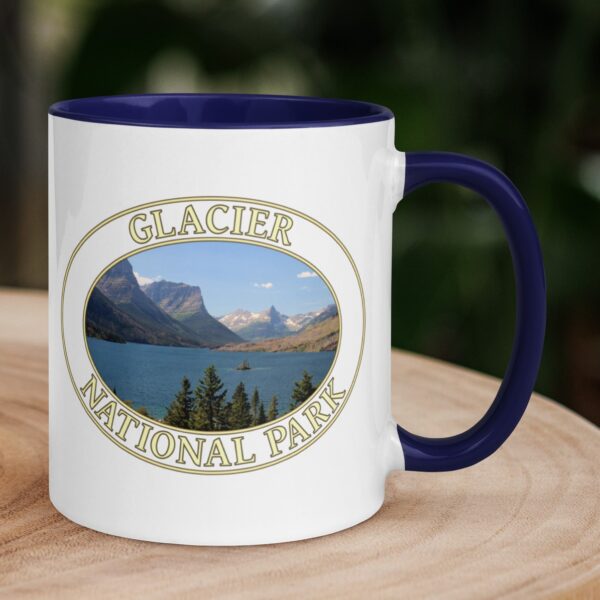 Saint Mary Lake Glacier National Park coffee mug featuring a scenic view of the lake’s crystal-clear waters, Wild Goose Island, and Montana mountain peaks, with a colorful handle and interior.