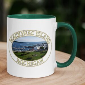 Harbor and downtown Mackinac Island Michigan coffee mug featuring a scenic waterfront view of the marina, historic buildings, and Lake Huron, with a colorful handle and interior.