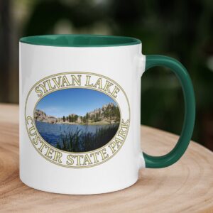 Sylvan Lake coffee mug featuring a scenic view of Custer State Park, South Dakota, with a colorful handle and rim.